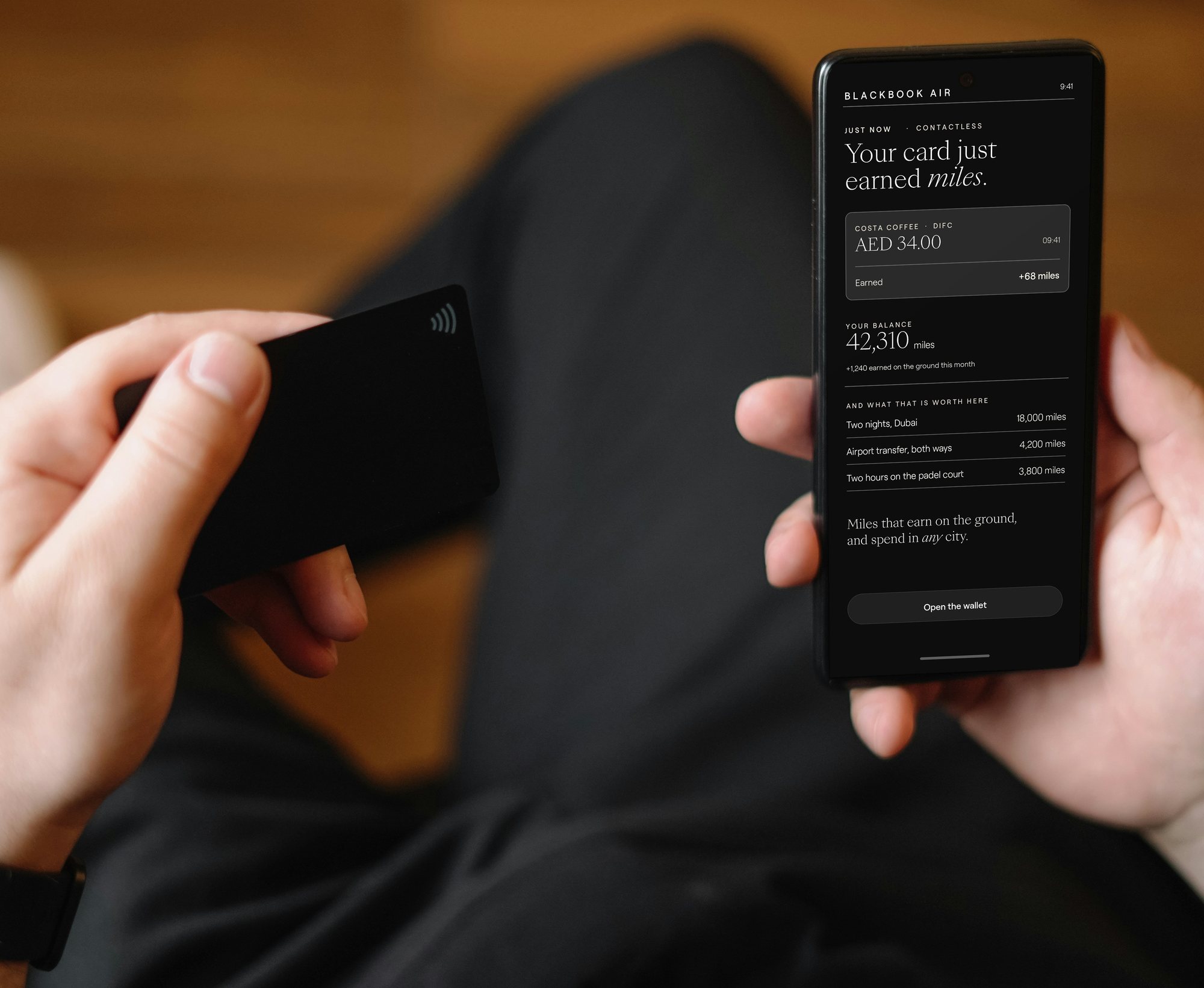 A contactless card in one hand and the app in the other, miles posting from the payment