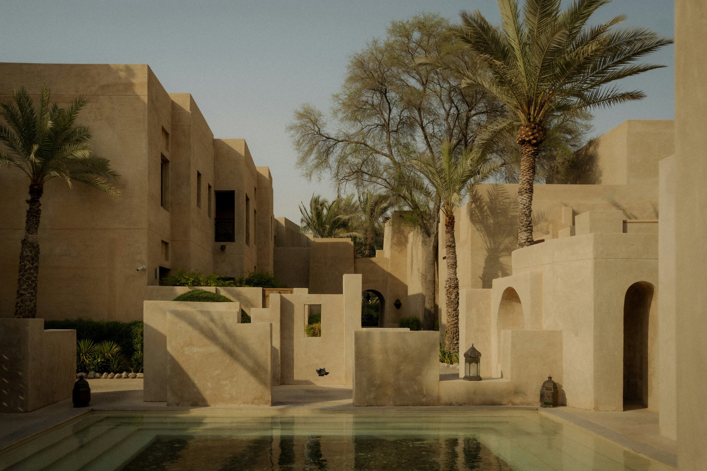 A courtyard pool among palms