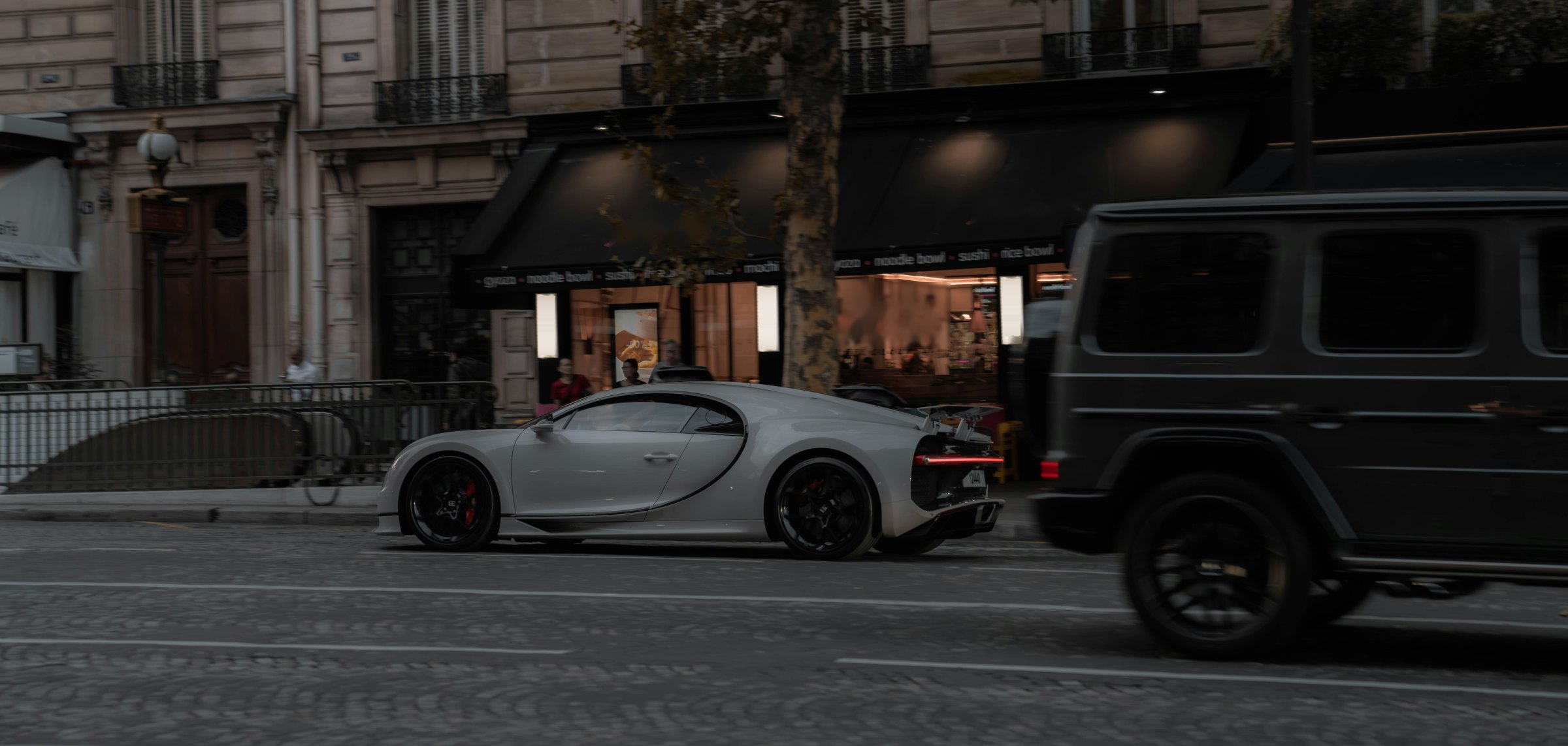 A car on a Paris street at dusk