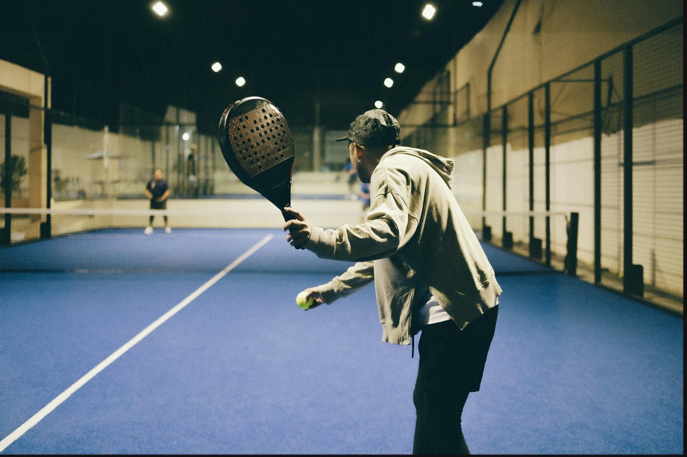 Padel, indoors at night
