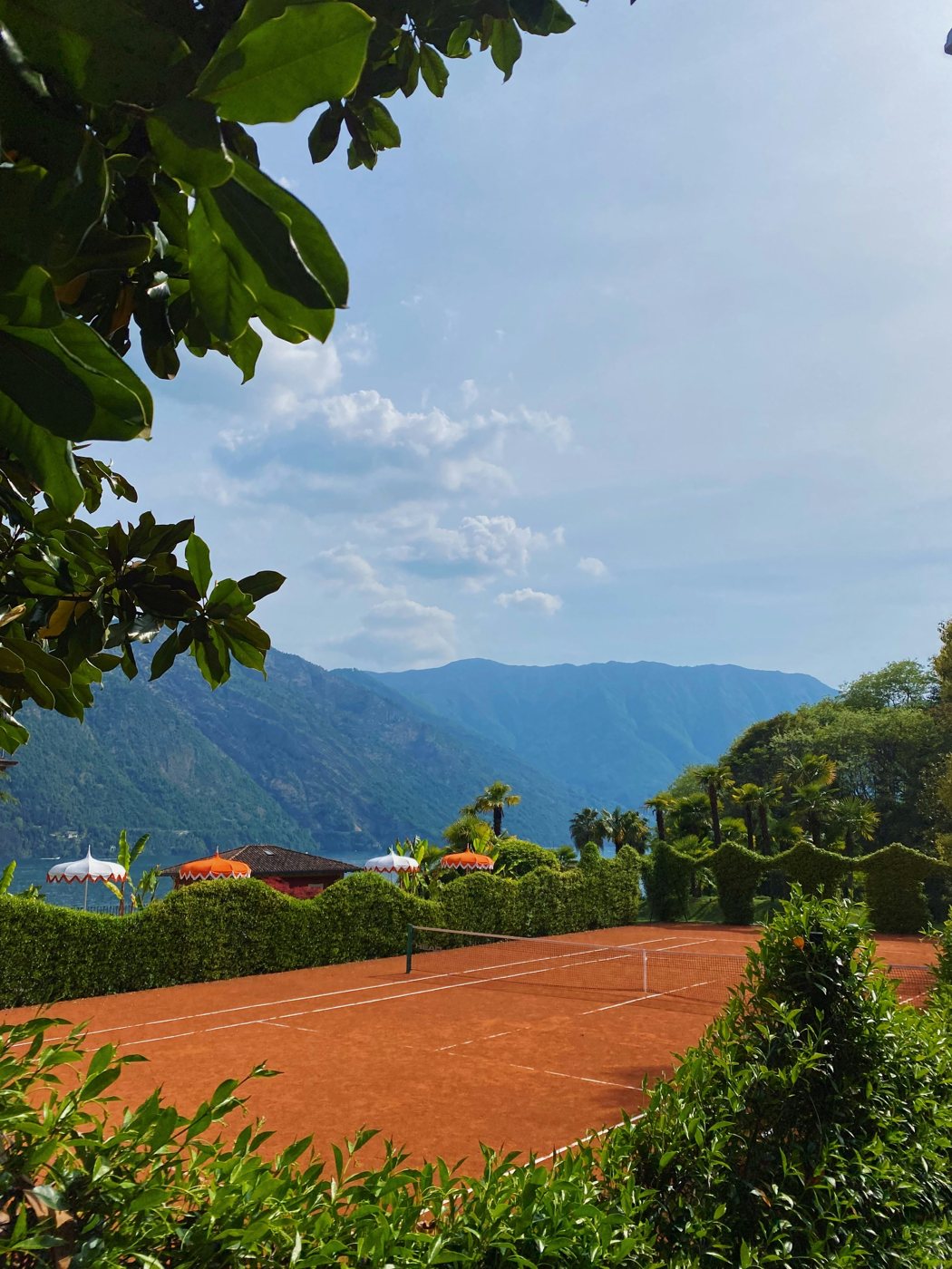 A clay court above a lake